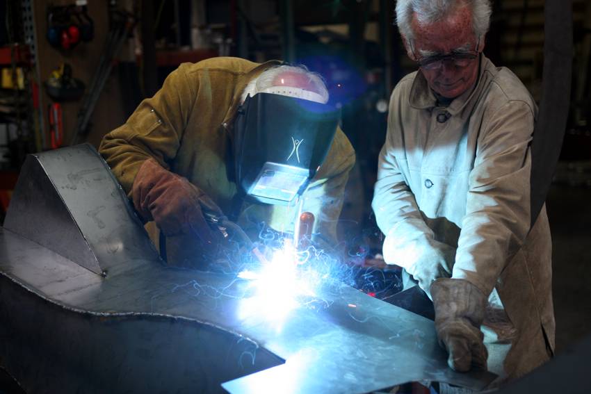 Bob Stokes and welder Gray Lucier construct the Avenue of the People